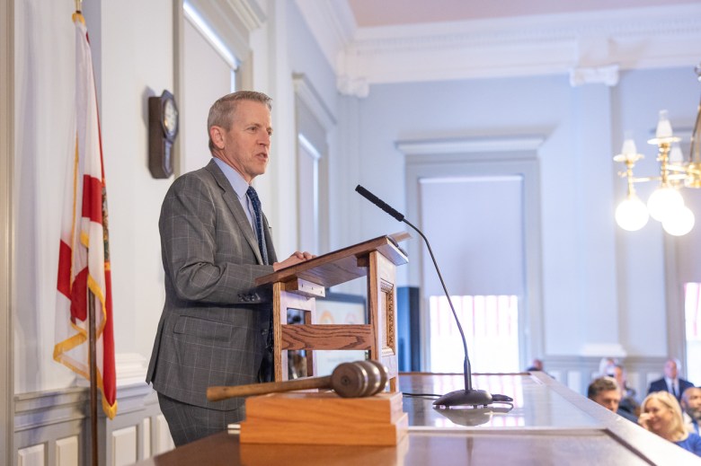 Paul Renner standing at a podium.