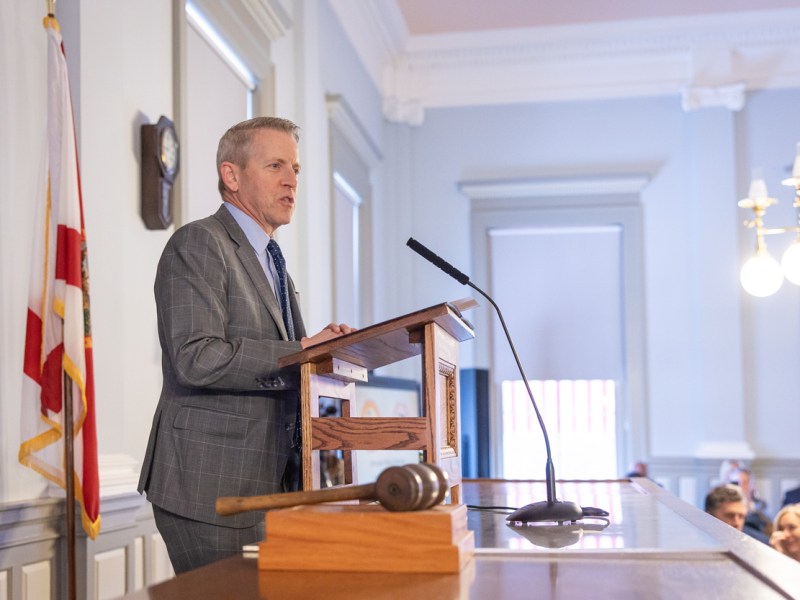 Paul Renner standing at a podium.